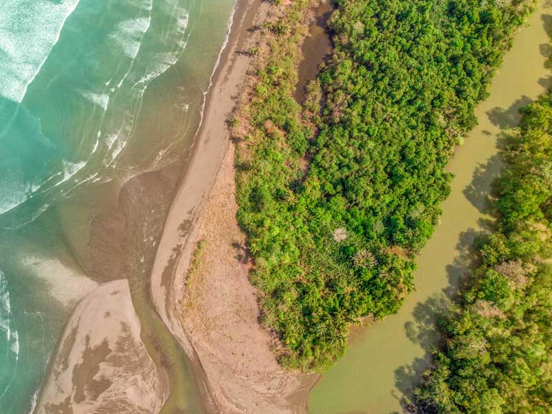 Uma vista aérea de uma praia e de uma massa de água.