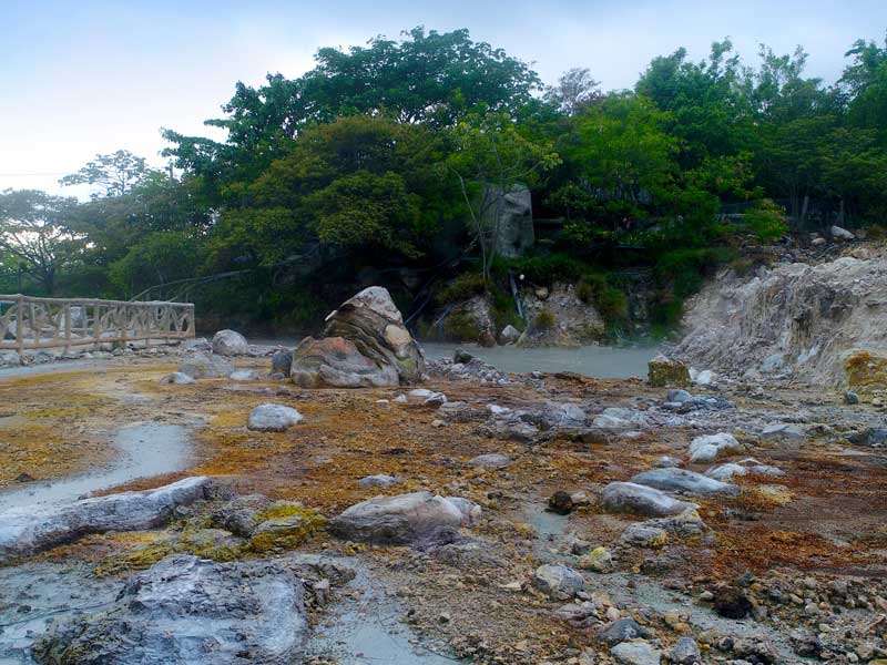 Um grande rochedo no cimo de um campo de terra batida.